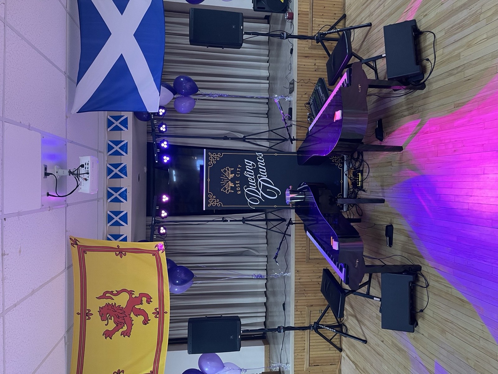 Stage setup at a Scottish themed event with flags