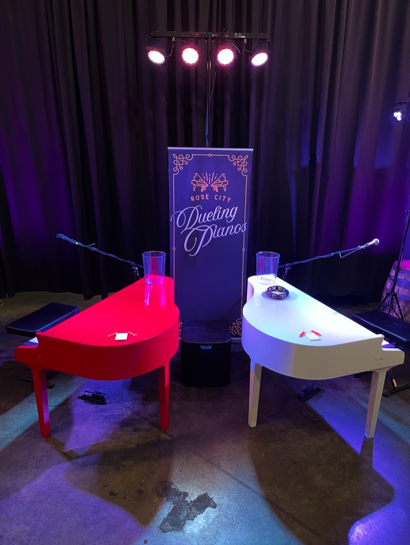 Intimate venue with RCDP banner between two pianos