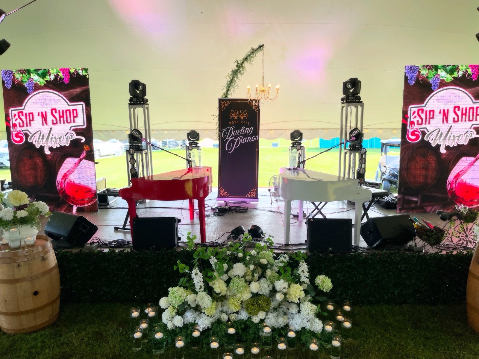 Outdoor stage setup with LED screens at Sip N Shop event